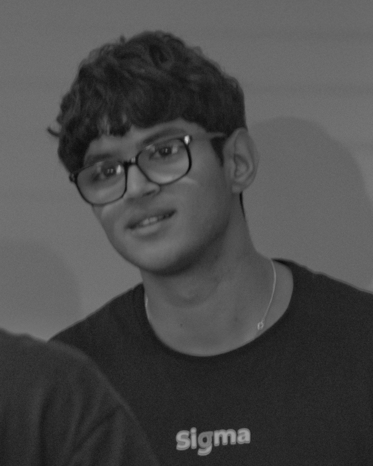 Nouh Khouyi in a Sigma Data Club T-shirt, talking with a club member at an event
